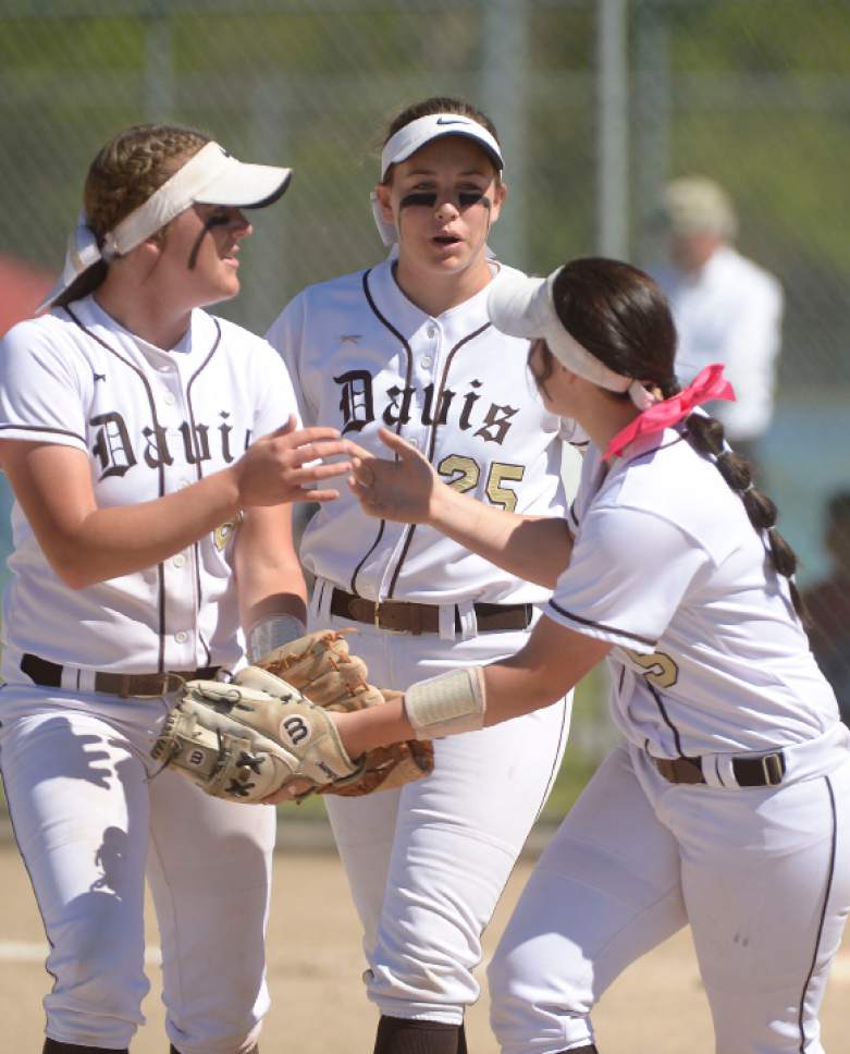 Leah Hogsten  |  The Salt Lake Tribune
Davis' l-r Carley Croshaw, Mia Cullimore and Paige Elkins celebrate an easy out. Copper Hills High School girls' softball team defeated Davis High School 5-4 in nine innings to win the quarterfinal game in the Class 5A Softball State playoff tournament at Valley Softball Complex, Tuesday, May 23, 2017.