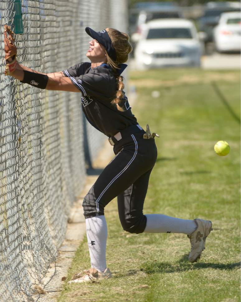 Leah Hogsten  |  The Salt Lake Tribune
Copper Hills' Kaylee Butterworth hits the fence trying to make the out. Copper Hills High School girls' softball team defeated Davis High School 5-4 in nine innings to win the quarterfinal game in the Class 5A Softball State playoff tournament at Valley Softball Complex, Tuesday, May 23, 2017.