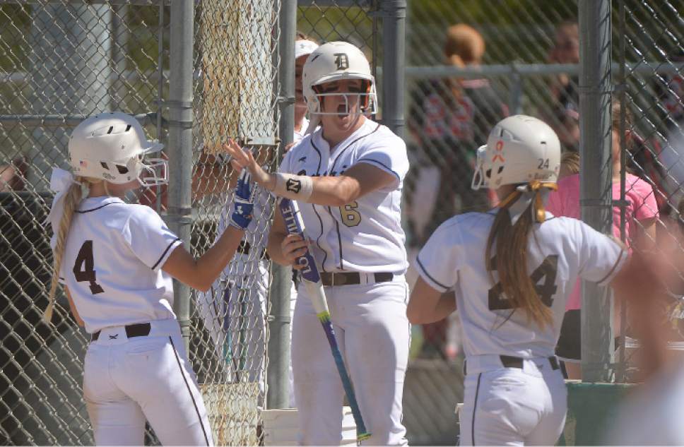 Leah Hogsten  |  The Salt Lake Tribune
Davis' Maggie Miller and Sidney Eyre celebrate their 2nd inning runs to take the lead. Copper Hills High School girls' softball team defeated Davis High School 5-4 in nine innings to win the quarterfinal game in the Class 5A Softball State playoff tournament at Valley Softball Complex, Tuesday, May 23, 2017.