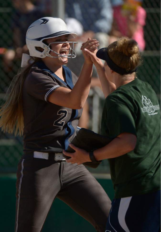 Leah Hogsten  |  The Salt Lake Tribune
Copper Hills' Portia Price celebrates her scoring run. Copper Hills High School girls' softball team defeated Davis High School 5-4 in nine innings to win the quarterfinal game in the Class 5A Softball State playoff tournament at Valley Softball Complex, Tuesday, May 23, 2017.