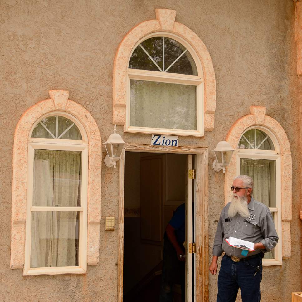 Trent Nelson  |  The Salt Lake Tribune
Mohave County Constable Mike Hoggard looks on as the locks are changed on a UEP Trust home in Colorado City, Ariz., Tuesday May 9, 2017.