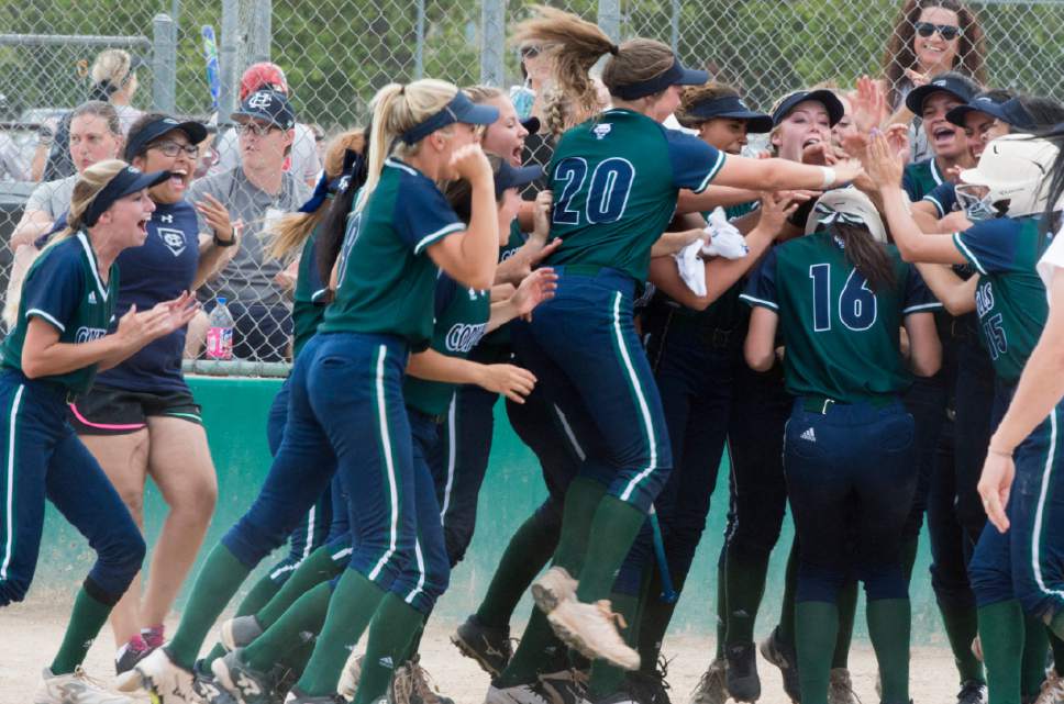 Rick Egan  |  The Salt Lake Tribune

Copper Hills greets Kaci Bobo (16)as she crosses the plate after hitting a home run, in the 5A softball state semifinal game, between West and Copper Hills, in Taylorsville, Thursday, May 25, 2017.