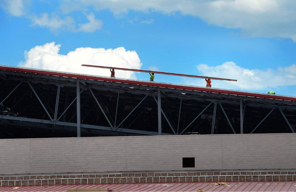 Scott Sommerdorf | The Salt Lake Tribune
Workers move roofing panels into place as RSL owner Dell Loy Hansen and RSL coach Mike Petke tour RSL's Herriman soccer complex, Wednesday, May 24, 2017.