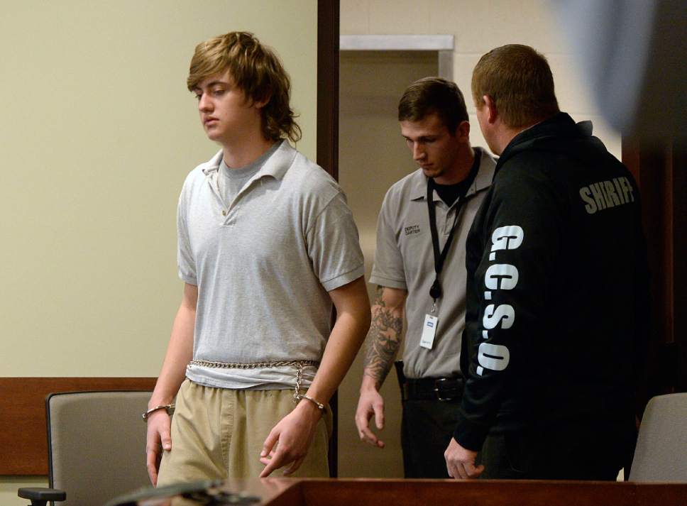 Al Hartmann  |  The Salt Lake Tribune                 
Clay Brewer, 17, of Snowflake, Arizona, left, is escorted into Judge Wallace Lee's 6th District Court in Panguitch Thursday Dec. 29 to make his first court appearance.  He is being charge as an adult with first-degree-felony counts of aggravated murder, attempted aggravated murder and aggravated robbery, as well as a third-degree-felony count of failure to stop at the command of police, and misdemeanor counts of tampering with evidence, reckless endangerment, theft and reckless driving. He is accused of killing 61-year-old Jimmy Woolsey during an attack at Turn-About Ranch School, located north of Escalante.