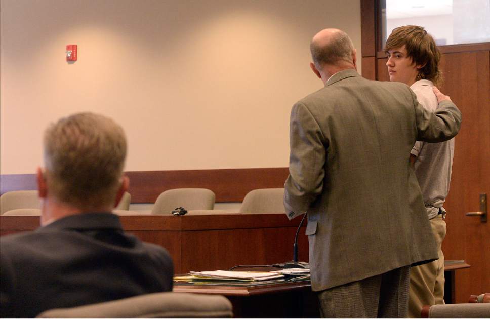 Al Hartmann  |  The Salt Lake Tribune                 
Clay Brewer, 17, of Snowflake, Arizona meets with his defense attorney Ron Yengich in Judge Wallace Lee's 6th District Court in Panguitch Thursday Dec. 29 to make his first court appearance.  Garfield County District Attorney Barry Huntington, left. He is being charge as an adult with first-degree-felony counts of aggravated murder, attempted aggravated murder and aggravated robbery, as well as a third-degree-felony count of failure to stop at the command of police, and misdemeanor counts of tampering with evidence, reckless endangerment, theft and reckless driving. He is accused of killing 61-year-old Jimmy Woolsey during an attack at Turn-About Ranch School, located north of Escalante.