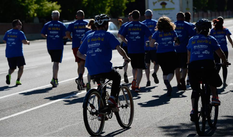 Francisco Kjolseth | The Salt Lake Tribune
Special Olympics athlete Jim Warden follows on a bike as members of the Draper Police Department participate in the annual Law Enforcement Torch Run for Special Olympics Utah by carrying the "Flame of Hope" from 11400 South State Street to Draper City Hall on Wed. May 24, 2017.