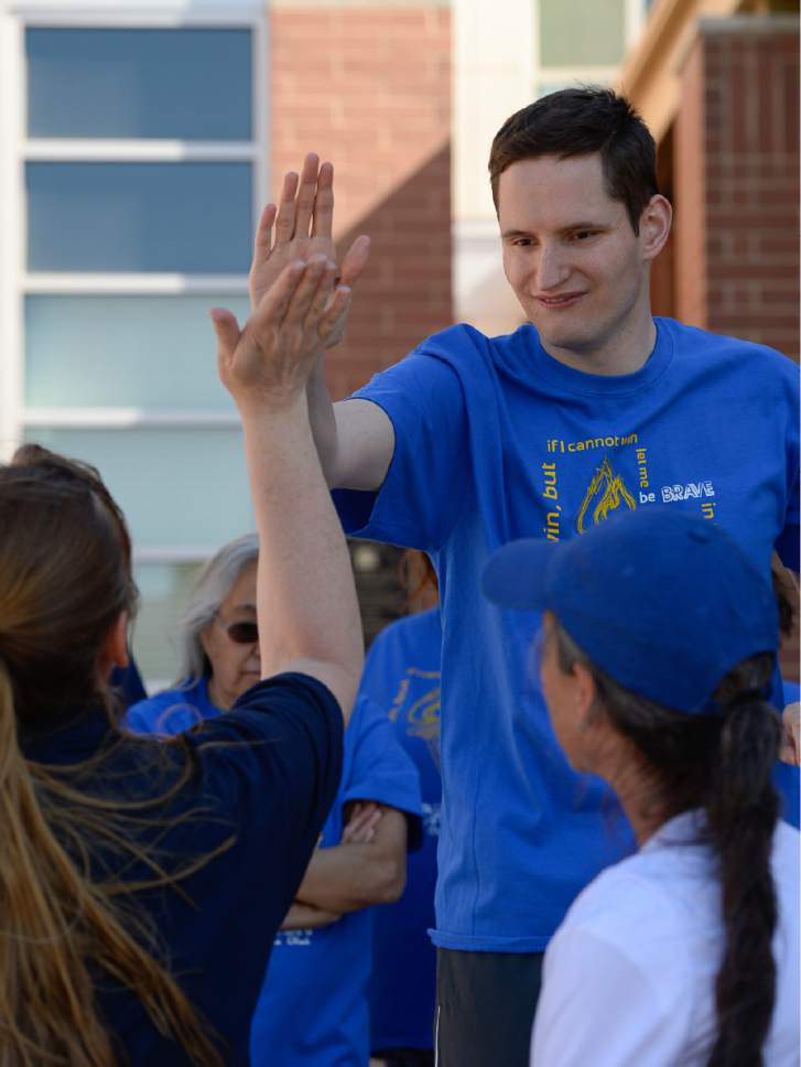 Francisco Kjolseth | The Salt Lake Tribune
Special Olympics athlete Truman Whitmer gives hight fives and fist bumps after arriving at Draper City Hall following the Torch Run for Special Olympics Utah by carrying the "Flame of Hope" on Wed. May 24, 2017.