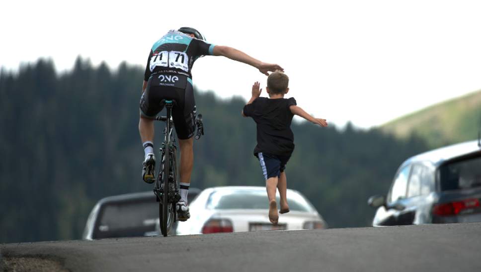 Leah Hogsten  |  The Salt Lake Tribune
Dion Smith with One Pro Cycling gets a high-five from Cache Cragan, 8, of Logan who ran beside him on Guardsman's Pass during Stage 6 of the Tour of Utah on Saturday, August 6, 2016 that took cyclists on a 114-mile ride with over 11,000 feet of climbing from Snowbasin Ski Resort to Snowbird.