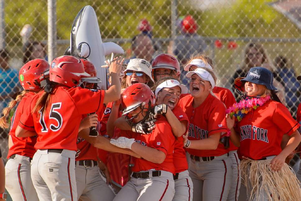 Trent Nelson  |  The Salt Lake Tribune
Spanish Fork's Gabby Beckstrom celebrates a home run with her teammates as Spanish Fork defeats Uintah High School in the Class 4A softball state title game in Taylorsville, Thursday May 25, 2017.