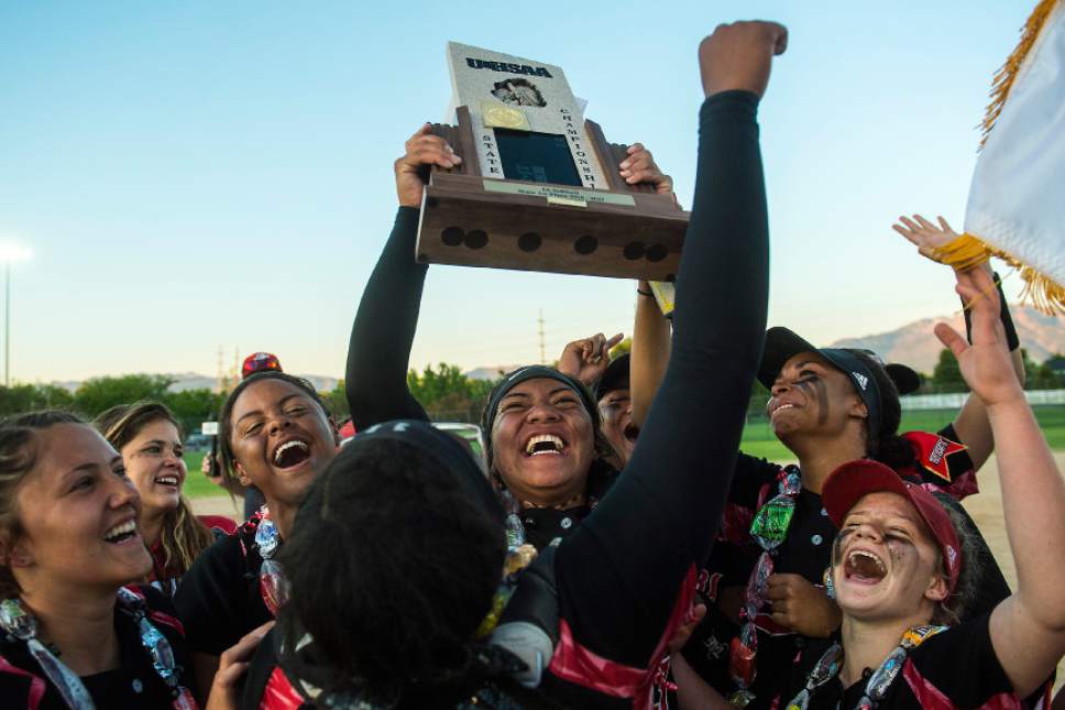 Chris Detrick  |  The Salt Lake Tribune
West's Rayna Aiono, holding the trophy, and her teammates celebrate after winning the Class 5A softball state championship game at Valley Softball Complex Thursday, May 25, 2017. West defeated Bingham 12-6.