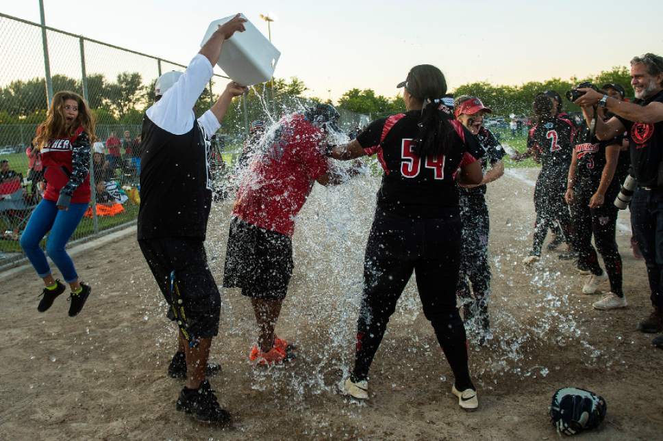Chris Detrick  |  The Salt Lake Tribune
Members of the West softball team celebrate by dumping a bucket of ice water on coach Keith Lopati after winning the Class 5A softball state championship game at Valley Softball Complex Thursday, May 25, 2017. West defeated Bingham 12-6.