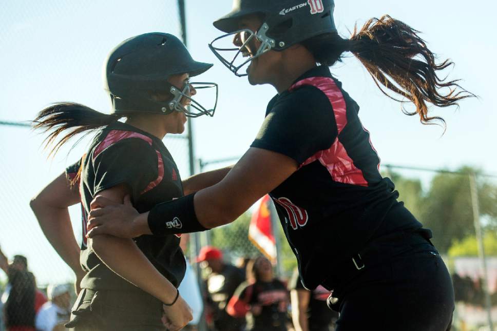 Chris Detrick  |  The Salt Lake Tribune
West's Kensey Lopati (3) and West's Kamora Masina (10) celebrate after scoring runs during the Class 5A softball state championship game at Valley Softball Complex Thursday, May 25, 2017. West defeated Bingham 12-6.