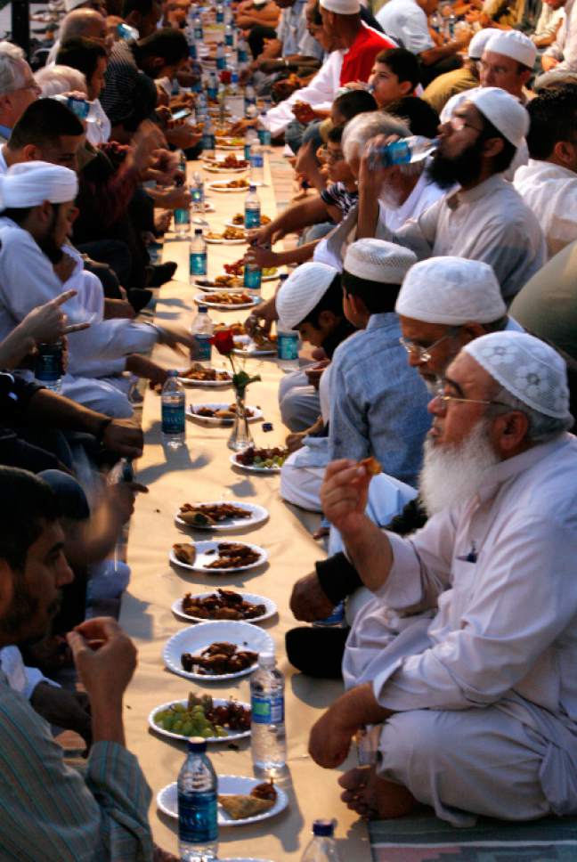 Rick Egan  |  The Salt Lake Tribune
Islam faithful eat a small bit of food to break their fast, before prayers in the Khadeeja Islamic Center in West Valley City for the community "iftar" or the breaking of the fast during Ramadan,  Saturday, Aug. 29,  2009.  Two Salt Lake City Mormon wards plan to host area Muslims for such an iftar meal on June 4, 2017.