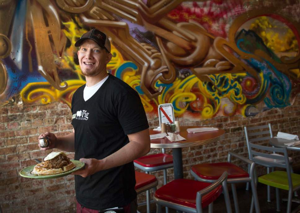 Leah Hogsten  |  The Salt Lake Tribune
Pig & A Jelly Jar server Chaz Hunter delivers a popular plate of Chicken and Waffles, Wednesday, May 24, 2017.
Pig & A Jelly Jar, a popular Salt Lake City restaurant, opened its second location in Ogden two years ago.