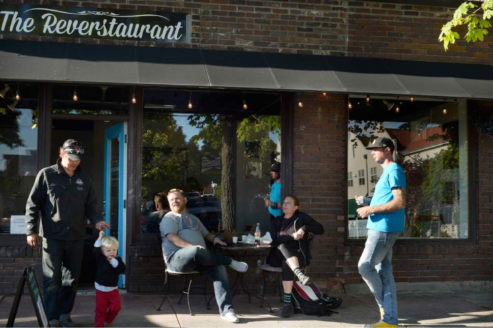 Scott Sommerdorf | The Salt Lake Tribune
People mingle and eat outside at the Reverstaurant, Friday, May 19, 2017.