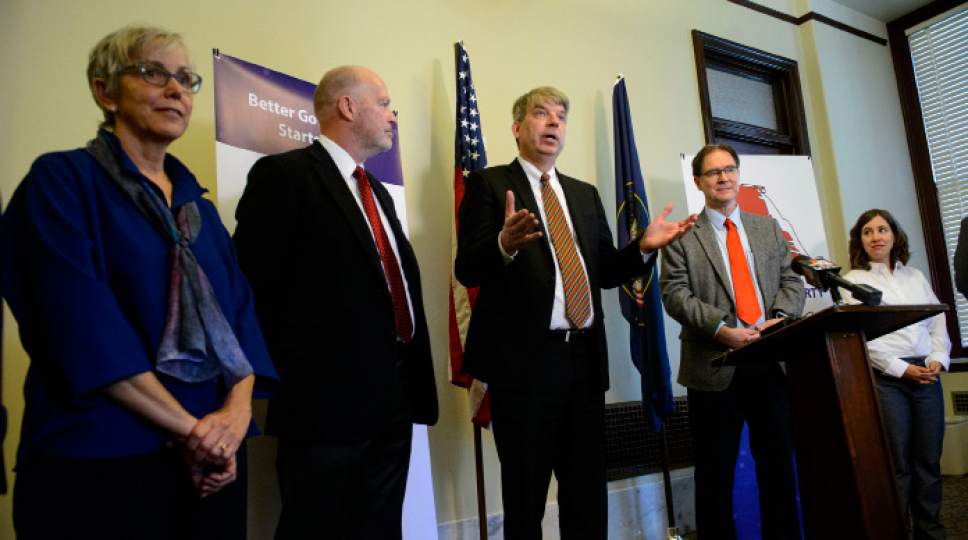 Steve Griffin  | Tribune file photo
Jim Bennett, center, amid members of the new United Utah Party, at the centrist political party's launch in May.  The party has sued in federal court, claiming state rules are unfairly blocking its ballot access.