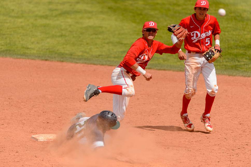 Trent Nelson  |  The Salt Lake Tribune
Spanish Fork's Tanner Argyle turns a double play as Spanish Fork faces Timpanogos High School in the Class 4A baseball state title game in Orem, Friday May 26, 2017.