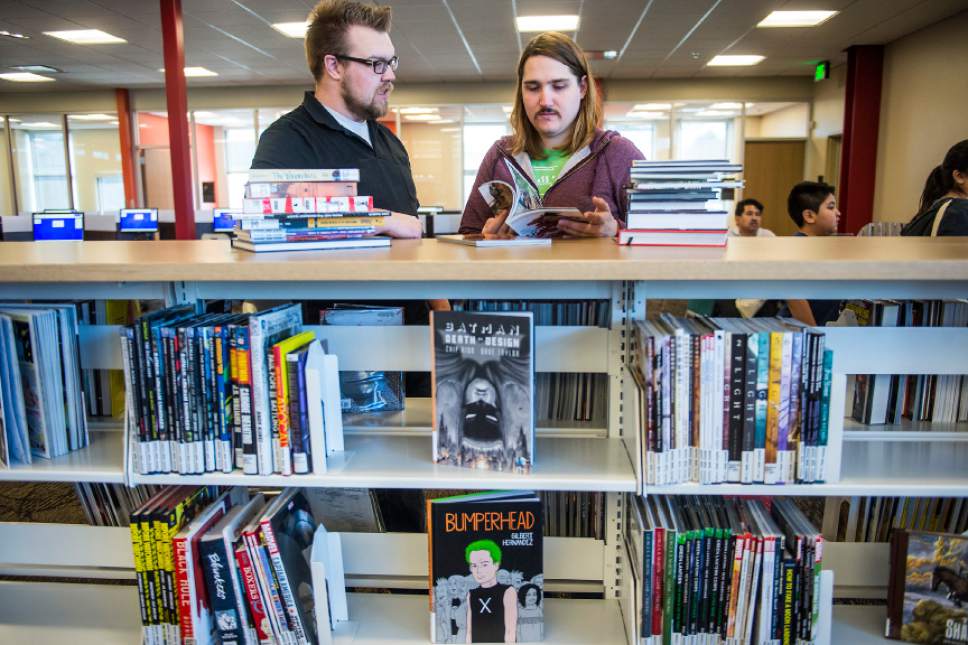 Chris Detrick  |  The Salt Lake Tribune
Eric Evans, of Salt Lake City, and Spencer Holt, of Rose Park, look at comic and cook books during the grand opening of the Glendale Branch library Saturday February 7, 2015.   The branch features nearly 20,000 square feet of space, making it the largest City Library branch, and offers 40,000 items for circulation. The branch also includes a large meeting facility, a designated teen space, and a floor plan that offers open views across the building.