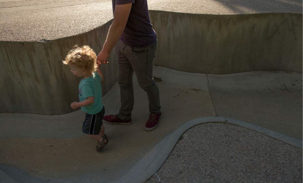 Leah Hogsten  |  The Salt Lake Tribune
Xander Nelson tugs on his father Blaine's hands while playing around the dry Seven Canyons fountain, Friday, May 26, 2017. Liberty Park's Seven Canyons fountain will not be operational for 2017.