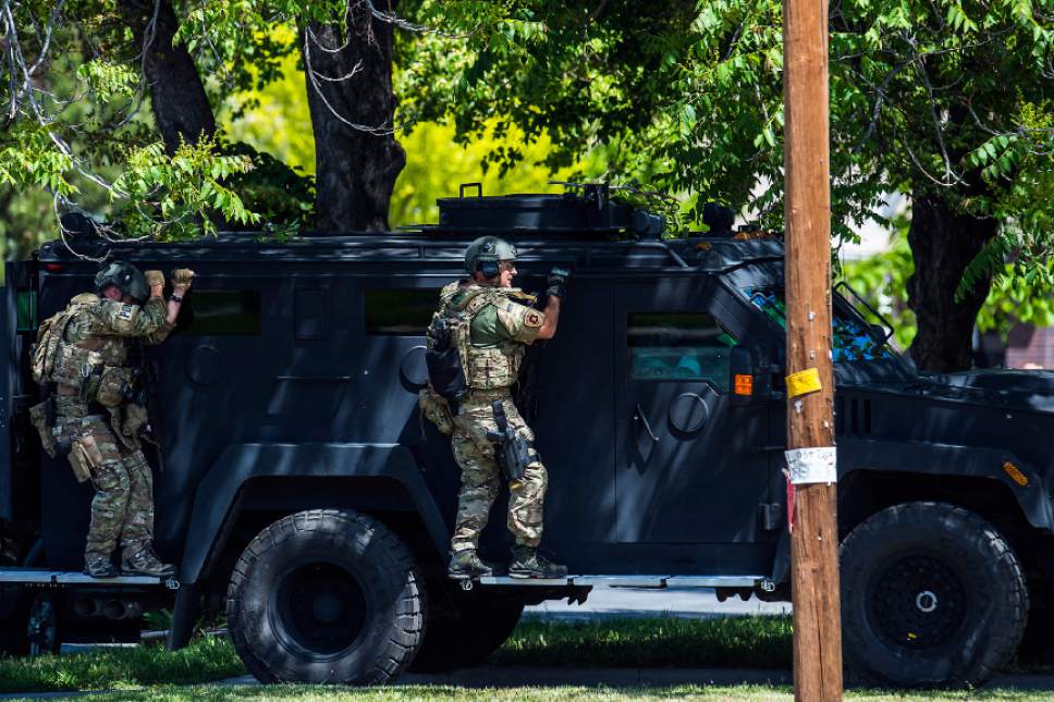 Chris Detrick  |  The Salt Lake Tribune
SWAT officers and Salt Lake Police surround a house near 800 South and 940 West Wednesday, May 24, 2017. After an hour and a half after police cordoned off an area of west Salt Lake City late Wednesday morning -- after possible gunshots were reported -- a SWAT team broke in the door of a home and found no one inside, KUTV reported.