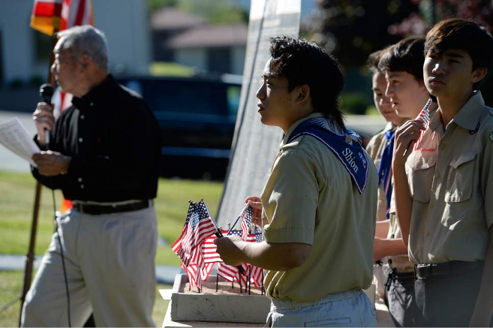 Scott Sommerdorf | The Salt Lake Tribune
Boy Scouts from Troop 1440, Dai Ichi Ward, assist as Raymond Uno reads from the list of names of Utah Japanese-American servicemen killed in World War II. The Utah Chapters of the Japanese American Citizen League on Sunday commemorated the sacrifices and honored the services of all Japanese-American veterans who have died.