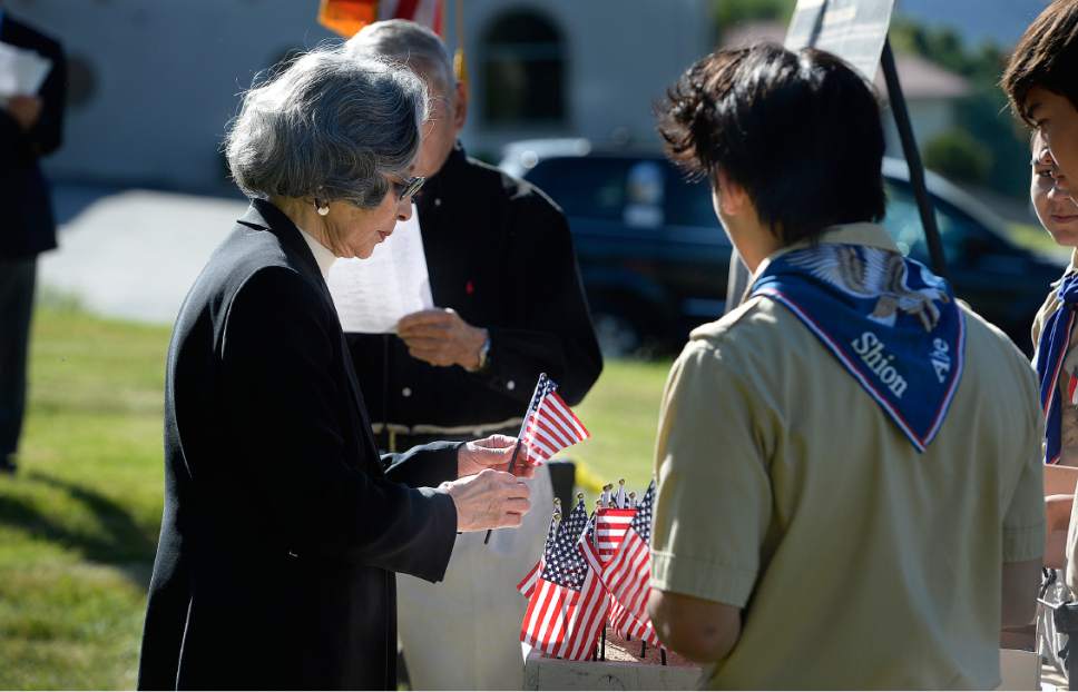 Scott Sommerdorf | The Salt Lake Tribune
Katie Misaka adds a flag to a group of others representing Utah's Japanese-American servicemen killed in World War II. The Utah Chapters of the Japanese American Citizen League on Sunday commemorated the sacrifices and honored the services of all Japanese-American veterans who have died.