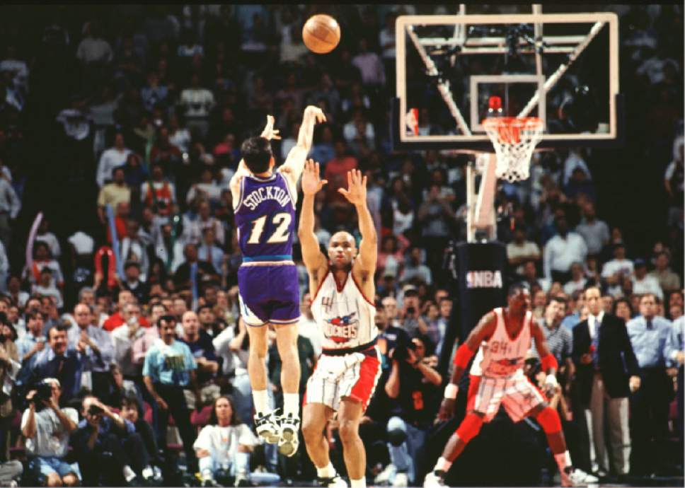 HOUSTON - MAY 29:  John Stockton #12 of the Utah Jazz shoots the game winning shot over Charles Barkley #34 of the Houston Rockets in Game six of the Western Conference Semifinals during the 1997 NBA Playoffs at the Compaq Center on May 29, 1997 in Houston, Texas.  NOTE TO USER: User expressly acknowledges  and agrees that, by downloading and or using this  photograph, User is consenting to the terms and conditions of the Getty Images License Agreement. Mandatory copyright notice: Copyright NBAE 1997  (Photo by Glenn James/NBAE via Getty Images)