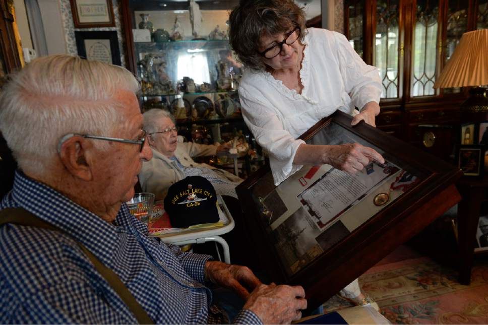 Francisco Kjolseth | The Salt Lake Tribune
Salt Lake City resident and WWII Navy vet Clayton James "Jim" Kearl, 96, alongside his wife Betty, 92, overlook a box of memorabilia held by their daughter Marianne Samuelson, one of 7 kids. Jim and his wife along with numerous family members will be traveling to D.C. on Saturday to lay the wreath at the WWII memorial and participate in the Memorial Day parade.