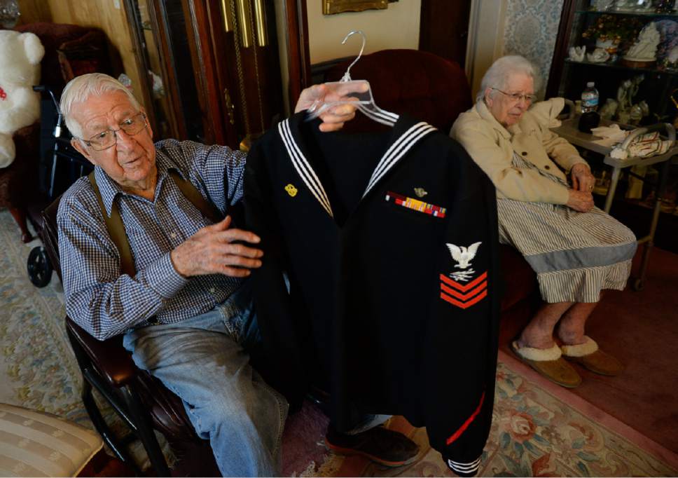 Francisco Kjolseth | The Salt Lake Tribune
Salt Lake City resident and WWII Navy vet Clayton James "Jim" Kearl, 96, shows off the navy jacket he plans to wear  to present the wreath at the Memorial Day Observance at the WWII Memorial in D.C. over the weekend. "I had to pick up a new one because I weighed 128 lbs when I got out of the service." At right is his wife Betty who he married while on leave in 1944.