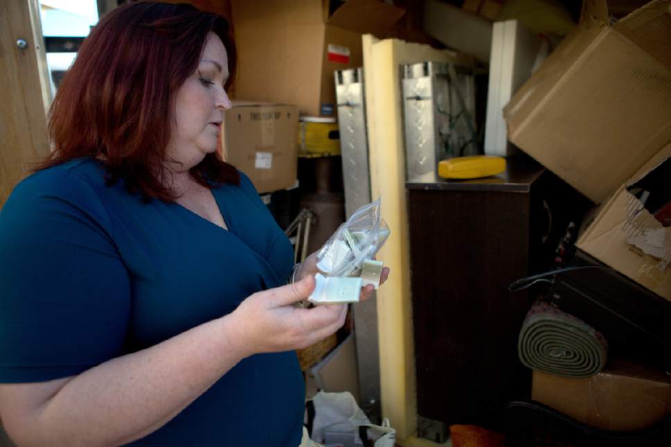 Jud Burkett  |  for The Salt Lake Tribune
Former Dixie State University student Victoria Willard describes her experiment with iron and titanium dioxide blends in ceramics as she holds a bag filled with ceramic test tiles Tuesday, May 23, 2017. Willard had packed the tiles in the trailer she and her husband have loaded to carry their belongings to their new home in New York state where Willard plans to continue her studies at Alfred University in the fall.