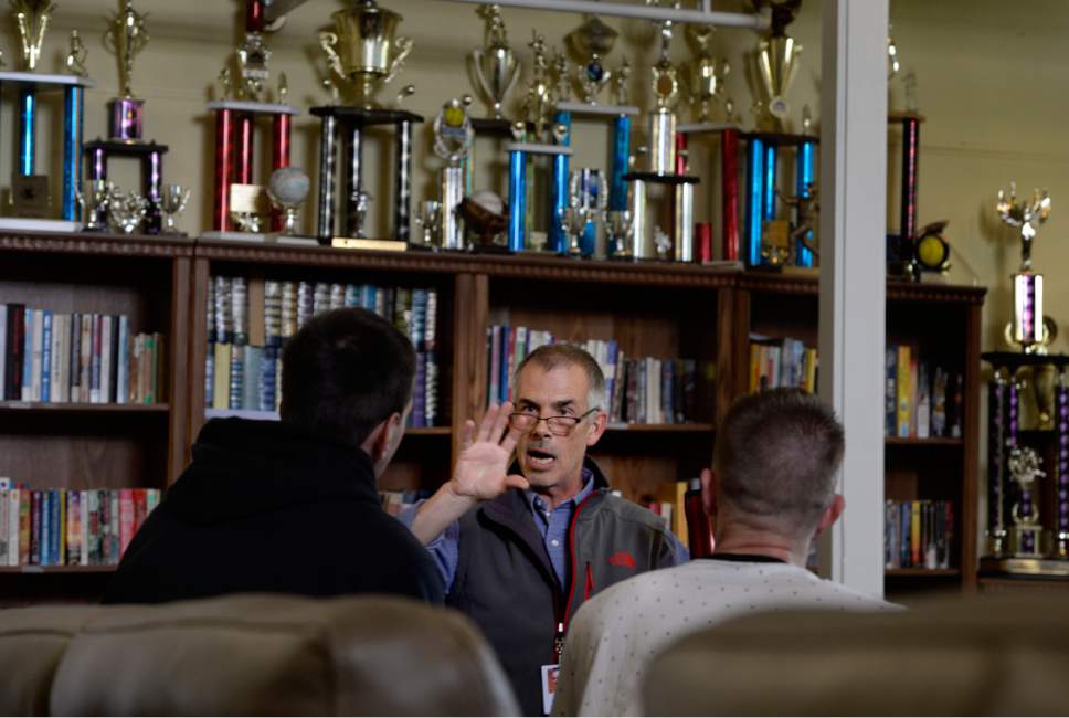 Scott Sommerdorf | The Salt Lake Tribune
Shawn McMillen, the executive director of First Step House talks with two men currently living at First Step House, Sunday, May 21, 2017. Some of the trophies the House softball teams have won can be seen behind McMillen.
Local law enforcement has taken an innovative approach around the 210 S. Rio Grande St. shelter, giving low-level drug offenders the chance to receive treatment instead of jail time. Some who were either rounded up during three sweeps last October, or visited the Salt Lake City Police Department's nearby Community Connection Center, have found help in drug addiction treatment at First Step House.