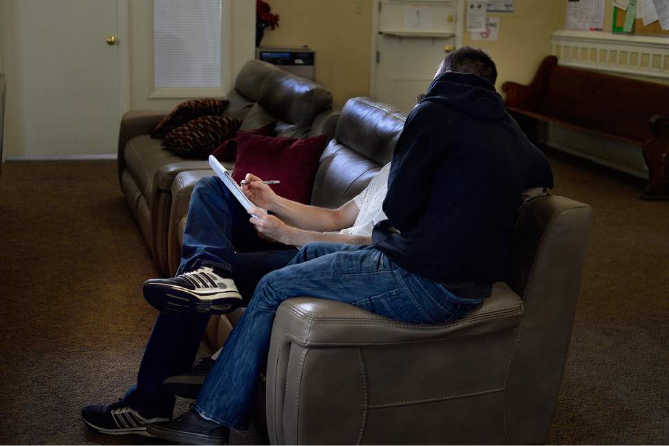 Scott Sommerdorf | The Salt Lake Tribune
Two men currently living at First Step House work on some written work they are required to do as part of heir treatment at First Step House, Sunday, May 21, 2017.
Local law enforcement has taken an innovative approach around the 210 S. Rio Grande St. shelter, giving low-level drug offenders the chance to receive treatment instead of jail time. Some who were either rounded up during three sweeps last October, or visited the Salt Lake City Police Department's nearby Community Connection Center, have found help in drug addiction treatment at First Step House.