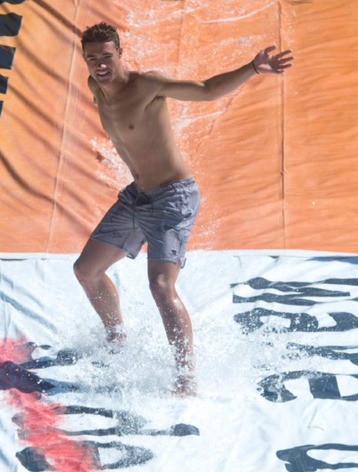 Rick Egan  |  The Salt Lake Tribune

Jake Dalley, surfs down a home made slipping' slide with water pumped from a stream, at Rock Canyon Park, Monday, May 29, 2017.