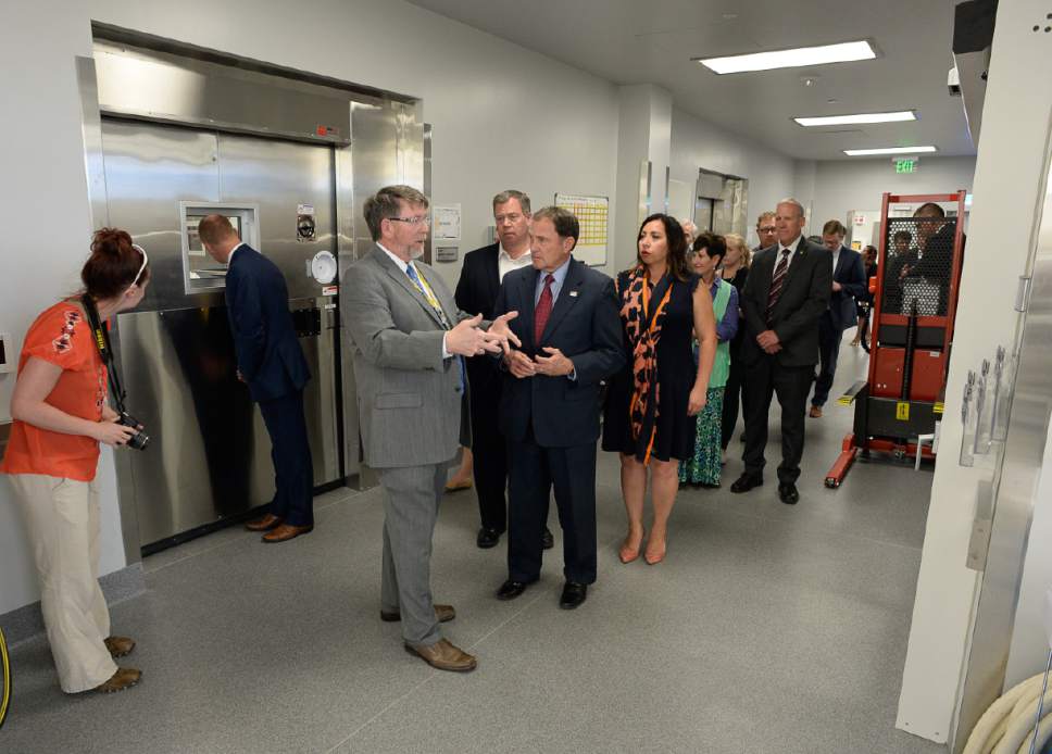 Francisco Kjolseth | The Salt Lake Tribune
Gov. Gary Herbert tours the body processing areas of the new State Crime Lab in Taylorsville as people peek into the coolers where bodies are kept on Thursday, June 1, 2017. Housing the Utah State Medical Examiner's Office and the Department of Agriculture the new building features a ballistics firing range, vehicle processing bays, trace evidence labs, chemistry labs and a robotic DNA testing lab.