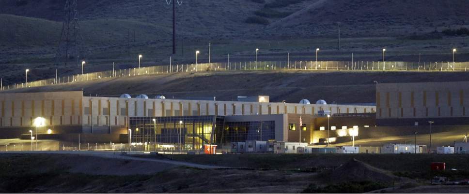 This Monday, June 10, 2013 photo shows a ground level view of Utah's NSA Data Center in Bluffdale, Utah.  The nation's new billion-dollar epicenter for fighting global cyberthreats sits just south of Salt Lake City, tucked away on a National Guard base at the foot of snow-capped mountains. The long, squat buildings span 1.5 million square feet, and are filled with super-powered computers designed to store massive amounts of information gathered secretly from phone calls and emails. (AP Photo/Rick Bowmer)