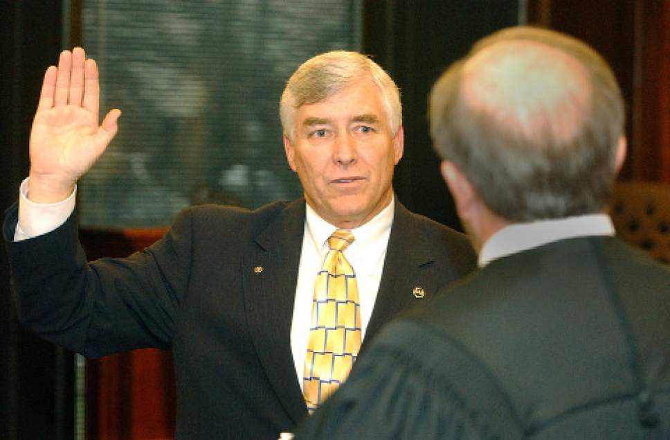 |  Tribune File Photo

Larry Ellertson is sworn in as Utah County commissioner by Uth County justice court judge Scott J. Cullimore at a ceremony in the council chambers on January 3, 2005.