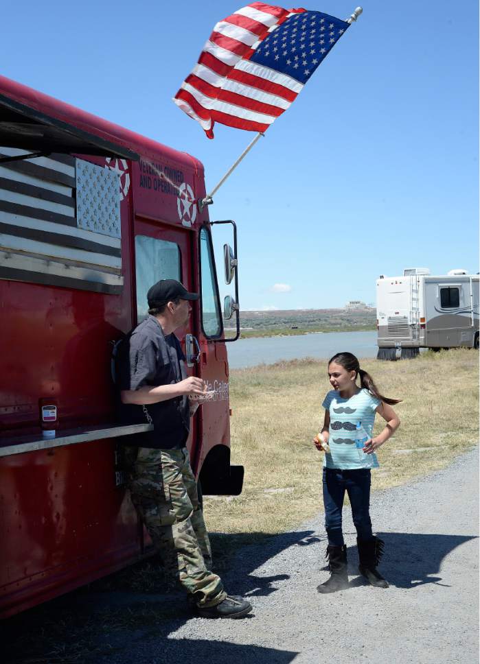 Scott Sommerdorf | The Salt Lake Tribune
James Veylupek, owner of the Special Courses food truck takes a break to eat lunch with his daughter Katie, Saturday, May 27, 2017.