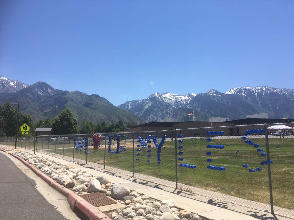 Tiffany Frandsen | The Salt Lake Tribune

"We (heart) U Myles": Message placed by students on a fence at Brookwood Elementary School on June 7, 2017.