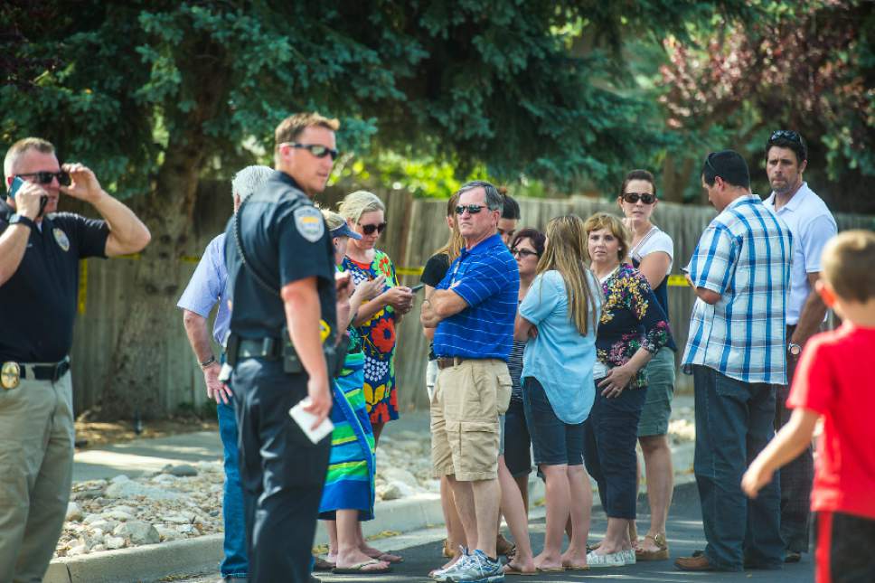 Chris Detrick  |  The Salt Lake Tribune
Community members look on as police officers investigate the scene of a shooting Tuesday, June 6, 2017. The shooting occurred at about 3:45 p.m. outside of a residence at about 2175 East and Alta Canyon Drive (about 8630 South), said Sandy police Sgt. Jason Nielsen. Nielsen said the shooter was among the dead and, therefore, there is no threat to the public.