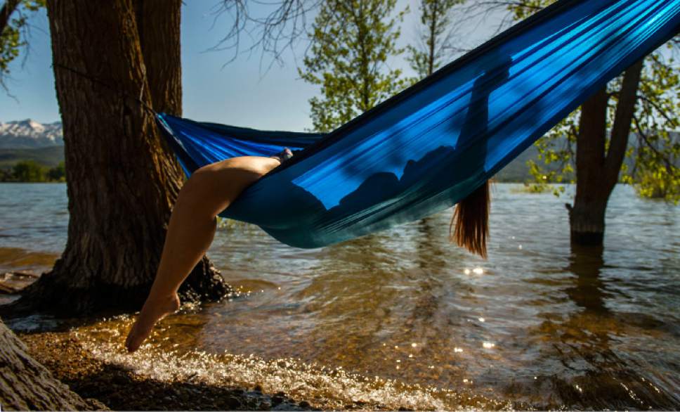 Leah Hogsten  |  The Salt Lake Tribune
"This is the third day in a row that I've been here," said Aubrey Garibay, 17, of Clearfield while relaxing in a hammock along the shore of Pineview Reservoir with her family, May 30, 2017.