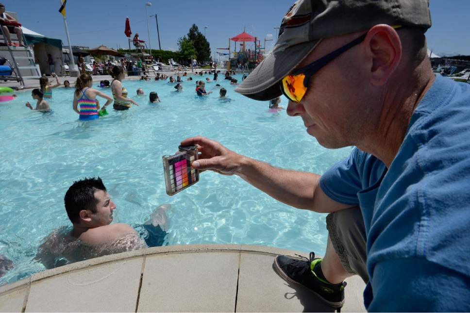 Scott Sommerdorf | The Salt Lake Tribune
Kurt Gailey takes measurements to determine the safety of the pool water at the Kearns Oquirrh Park Fitness Center, Wednesday, June 7, 2017. The Salt Lake County Health Department held its annual Healthy Swimming day to remind swimmers to keep pool water out of their mouths.