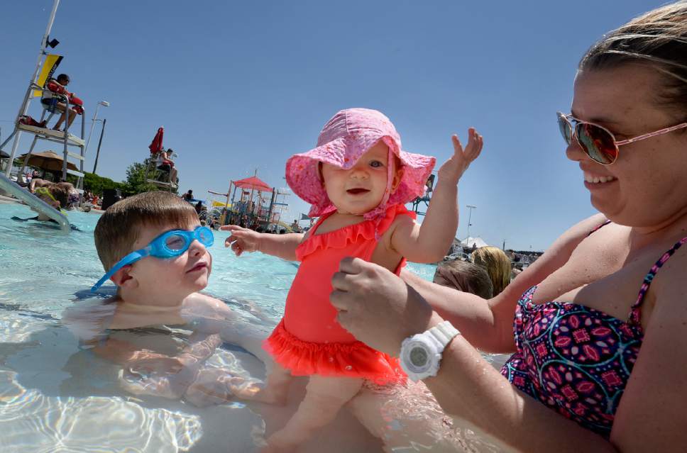 Scott Sommerdorf | The Salt Lake Tribune
Taryn Wright holds her 10- month-old daughter, Scarlett, as her 8-year-old brother, Weston, sits nearby at the Kearns Oquirrh Park Fitness Center on Wednesday. The Salt Lake County Health Department held its annual Healthy Swimming day to remind swimmers to keep pool water out of their mouths.