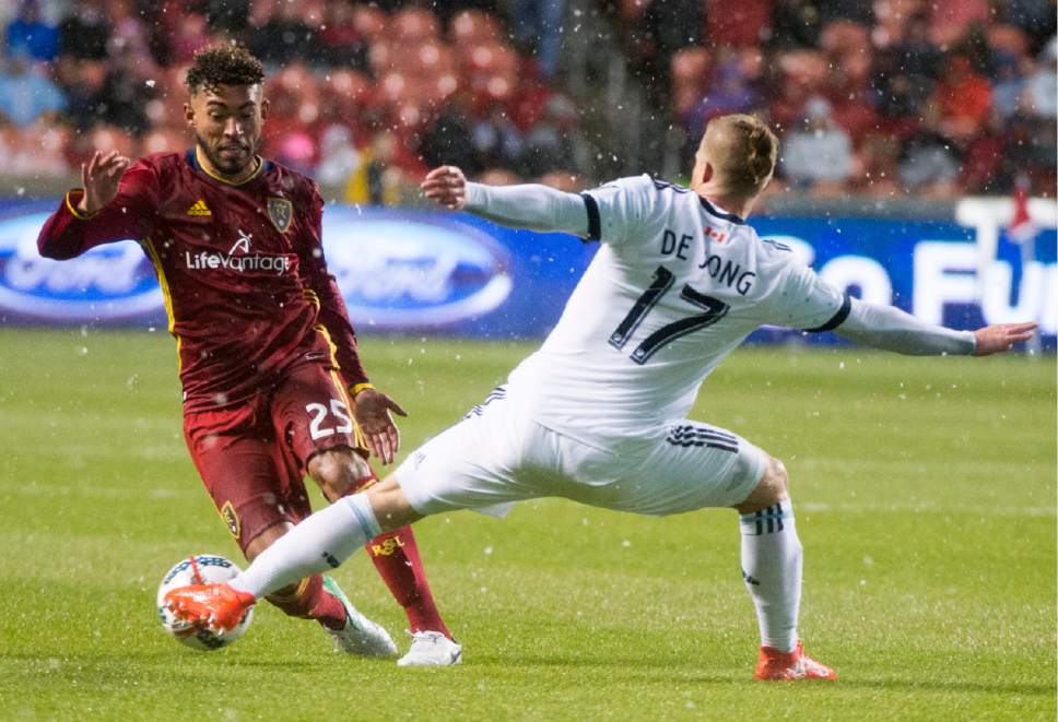 Rick Egan  |  The Salt Lake Tribune

Real Salt Lake midfielder Danilo Acosta (25) tries to get the ball past Vancouver defender,Nicolas Mezquida (11), in MLS action, at Rio Tinto Stadium, Saturday, April 8, 2017.