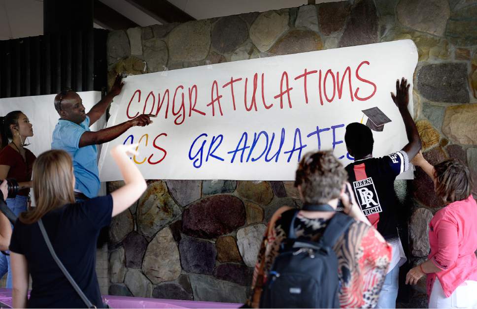 Scott Sommerdorf | The Salt Lake Tribune
A banner is put up congratulating the 14 refugee and foster care teens who earned their high school diplomas this year. The celebration was held at Jordan Park, Friday, June 9, 2017.
