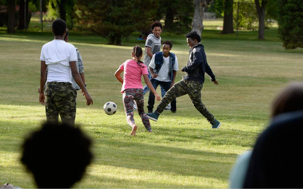 Scott Sommerdorf | The Salt Lake Tribune
Students play soccer prior to a graduation ceremony for 14 refugee and foster care teens who earned their high school diplomas this year. The celebration was held at Jordan Park, Friday, June 9, 2017.