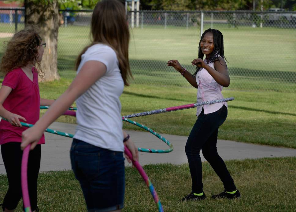 Scott Sommerdorf | The Salt Lake Tribune
Jolly Karungi, a refugee from The Congo smiles as she hula hoops with other students at a party for 14 refugee foster care teens who earned their high school diplomas this year. The celebration put on by Catholic Community Services of Utah, and was held at Jordan Park, Friday, June 9, 2017.