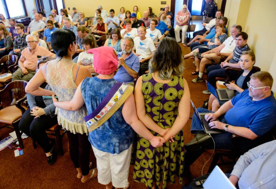 Steve Griffin  |  The Salt Lake Tribune


As Rob Miller, a Utah Democratic Party Chairman candidate speaks, audience members stand arm-in-arm with their backs to him and all of the candidates during a  town hall meeting at the State Capitol in Salt Lake City Wednesday June 7, 2017. The meeting comes after party officials had a meeting about what to do with allegations about sexual harassment against Miller.