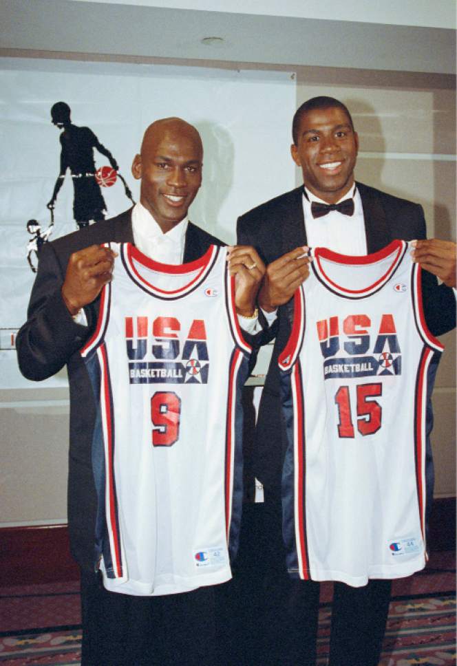 FILE - This Sept. 21, 1991 file photo shows Michael Jordan, left, and Earvin "Magic" Johnson holding their uniforms for the 1992 US Olympic Basketball team in Chicago. Cleveland Cavaliers star LeBron James knows who his dream teammates would be in a 3-on-3 competition at the 2020 Olympics _ Michael Jordan and Magic Johnson. James didn't think he would consider playing in the new Olympic event in the Tokyo Games, but is happy it was added. (AP Photo/Ralf-Finn Hestoft, file)