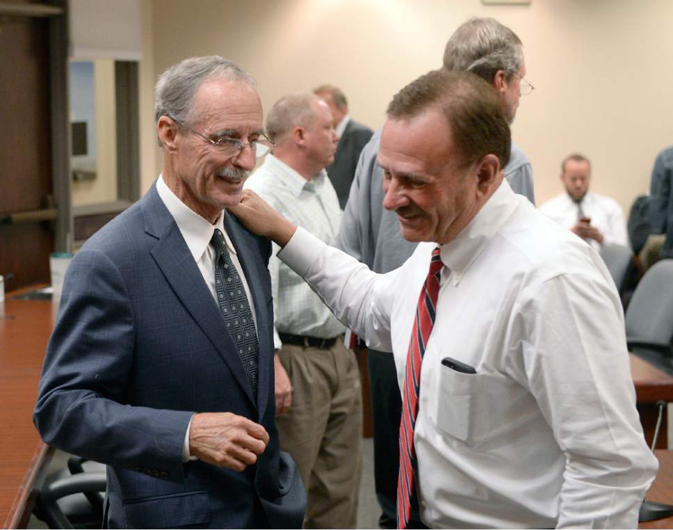 Al Hartmann  |  The Salt Lake Tribune
Salt Lake County Council Chair Max Burdick, right, pats the shoulder of Salt Lake County County Recorder Gary Ott after he spoke on findings of the County Auditor's performance audit of his office Tuesday Oct. 4.