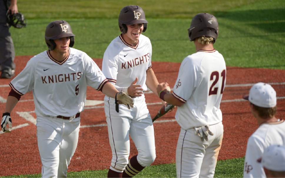 Leah Hogsten  |  The Salt Lake Tribune 
l-r Lone Peak's Payton Freeman and Seth Corry celebrate their runs in the bottom of the sixth to take the one run lead over Pleasant Grove in the bottom of the sixth.  Lone Peak High School boys' baseball team defeated Pleasant Grove High School 8-5 during their game Monday, May 8, 2017.